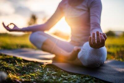 Close up of yoga outdoor at sunset.Virtual wellness.