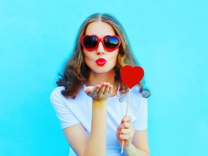 woman with red heart lollipop