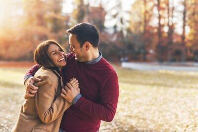 Couple in love hugging with romance and enjoying at public park in autumn