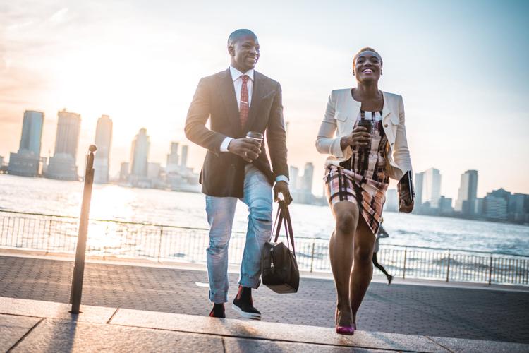 A young professional happily walking in London after being matched by Maclynn's dating agency.