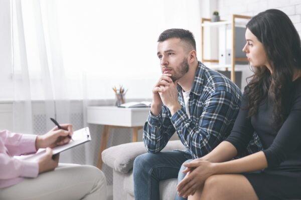 Family crisis. Young grumpy couple at marital counseling therapy, free space, relationship advice