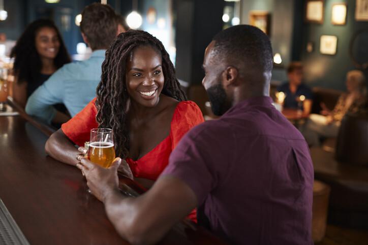 Couple On Date Sitting At Bar Counter And Talking