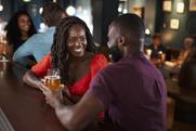 Couple On Date Sitting At Bar Counter And Talking