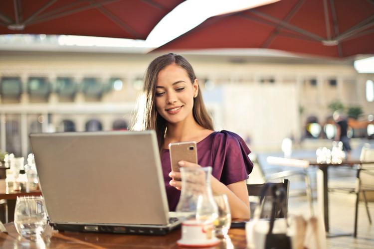 Lady on her phone and computer