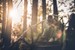 Young loving couple sitting on staircase in nature and enjoying in their love at sunset.