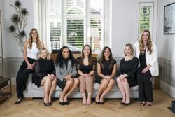 female, Maclynn team, sitting on sofa